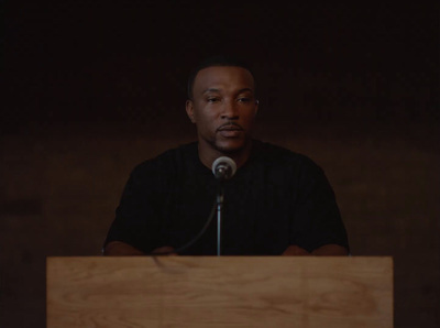 a man standing at a podium in front of a microphone