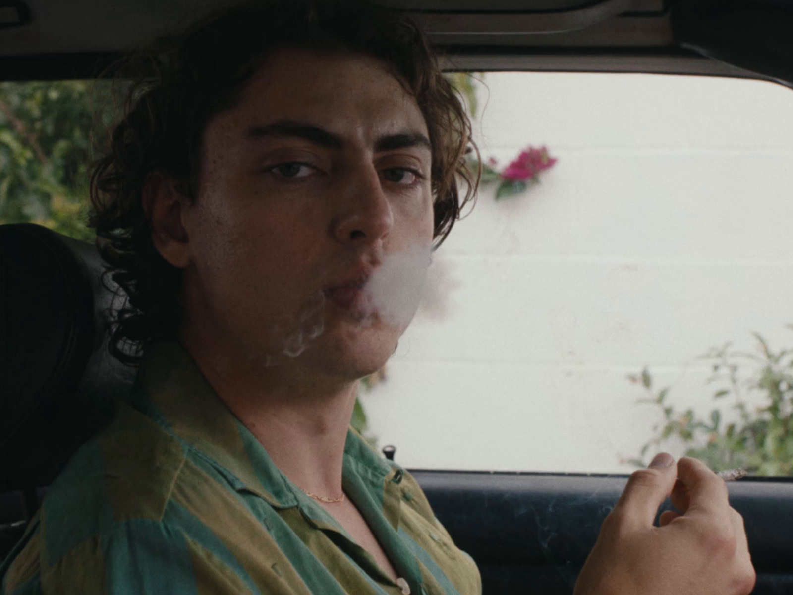 a man smoking a cigarette in a car