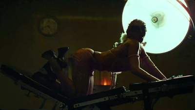 a woman is sitting on a machine in the dark