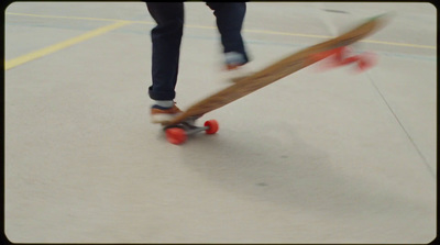 a person riding a skateboard on a court