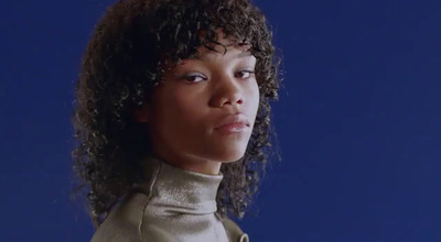 a close up of a person with curly hair