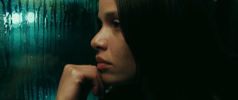 a woman looking out of a train window