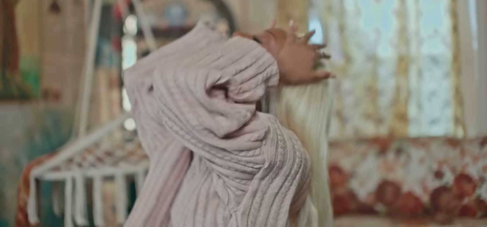 a doll is wrapped in a blanket in a room