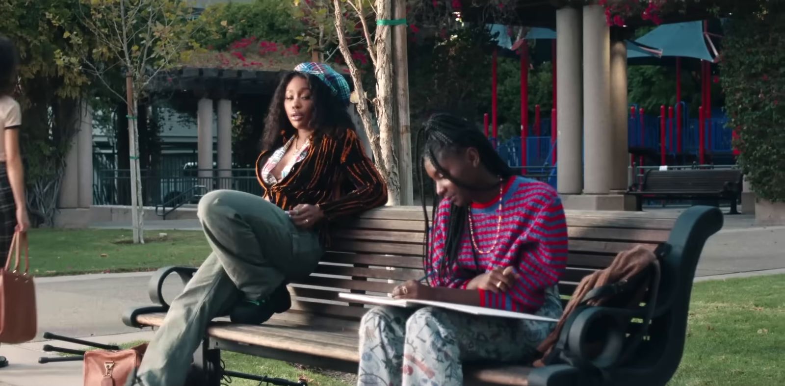 a woman sitting on a bench next to a man