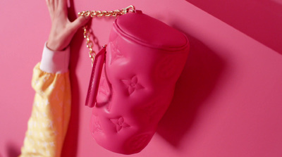 a pink purse hanging on a pink wall