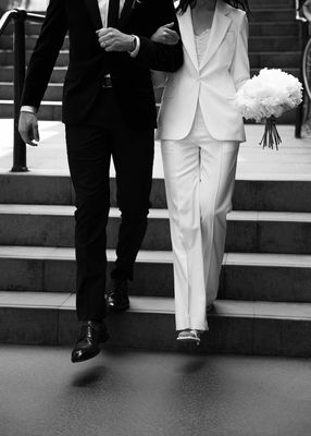 a man and a woman walking down a set of stairs