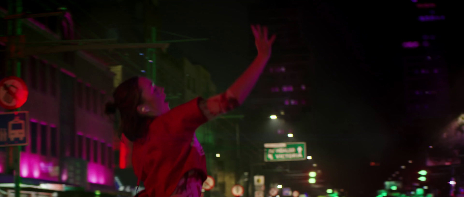 a man in a red shirt jumping in the air