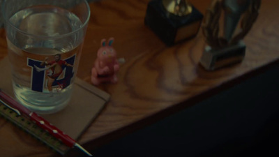 a glass of water sitting on top of a wooden table