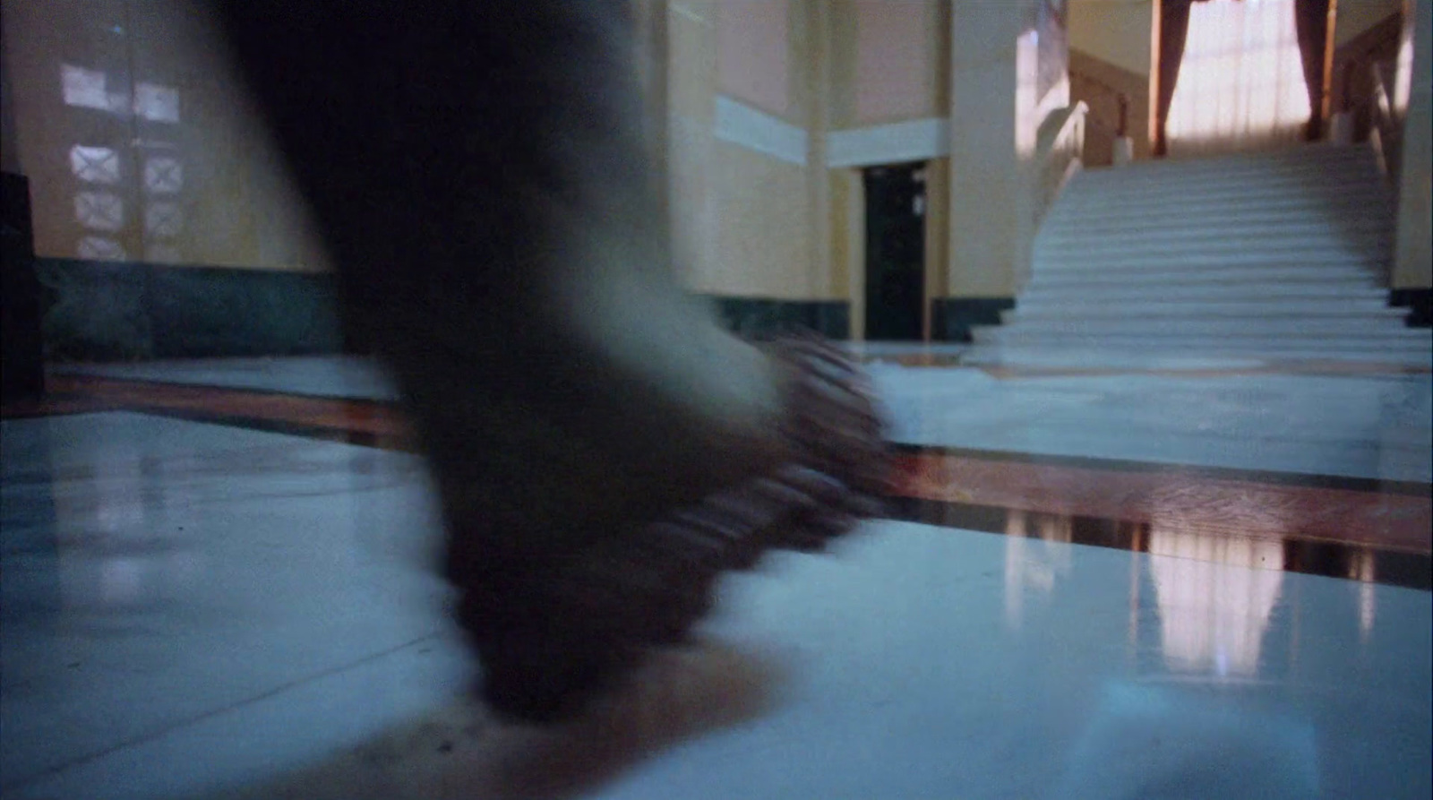 a blurry photo of a person walking down a hall