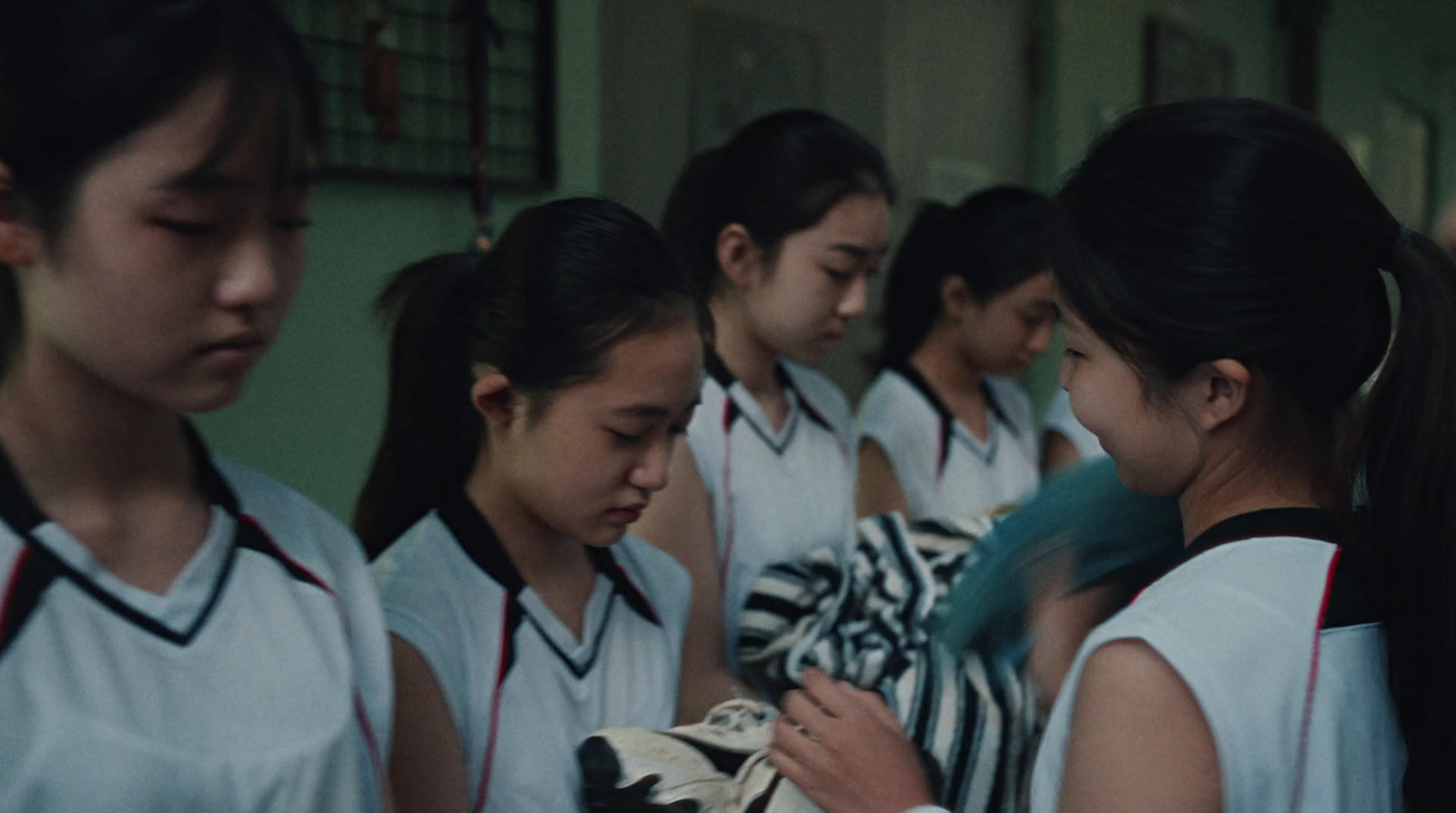 a group of young girls standing next to each other