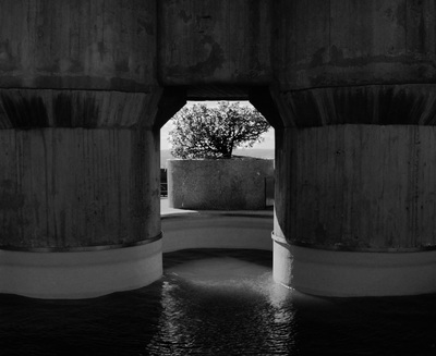 a black and white photo of water under a bridge