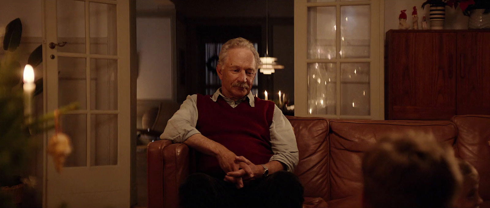 a man sitting on a couch in a living room