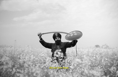 a man holding a paddle in a field of flowers