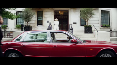 a red car parked in front of a building