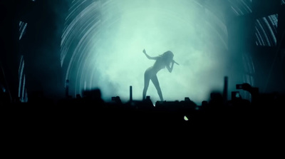 a woman standing on a stage in front of a crowd