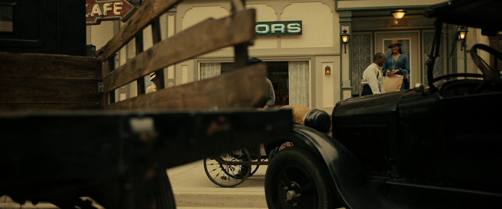 an old car is parked in front of a store