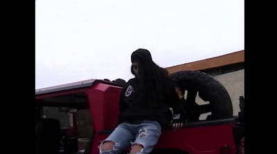 a person sitting on the back of a red truck