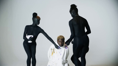 a group of three women in black bodysuits