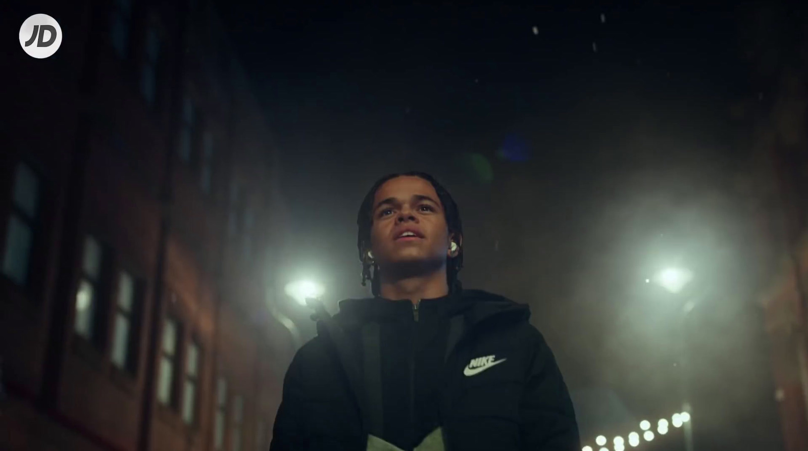 a man standing in front of a building at night