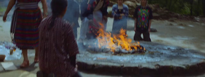 a group of people standing around a fire pit