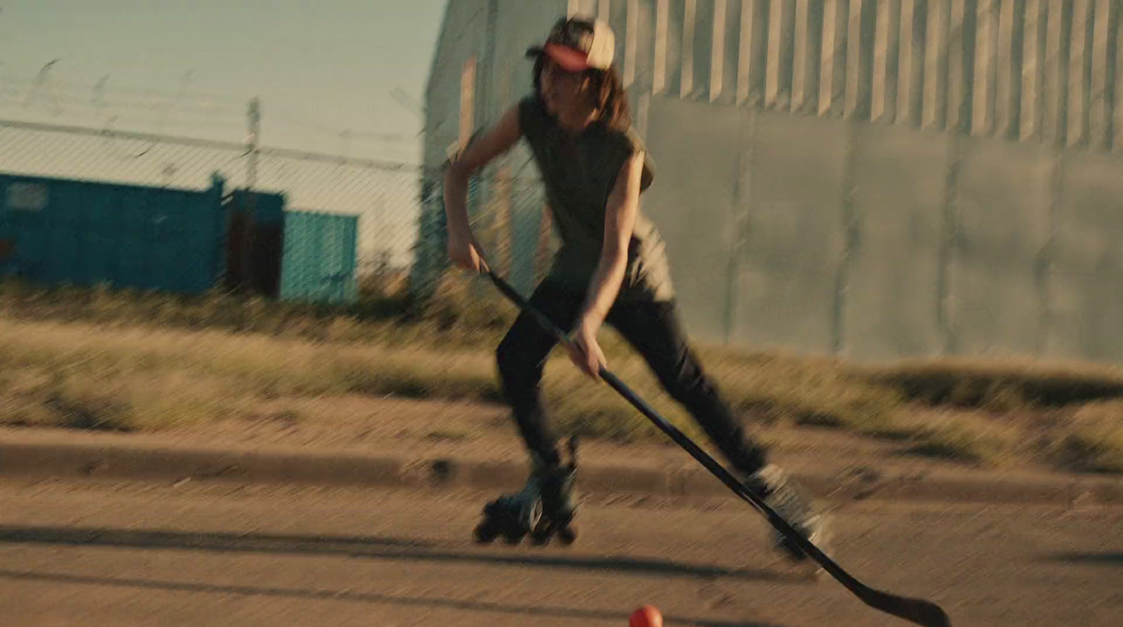 a woman riding a skateboard down a street