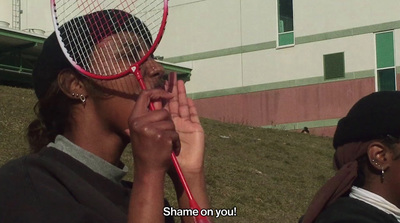 a woman holding a tennis racket up to her face