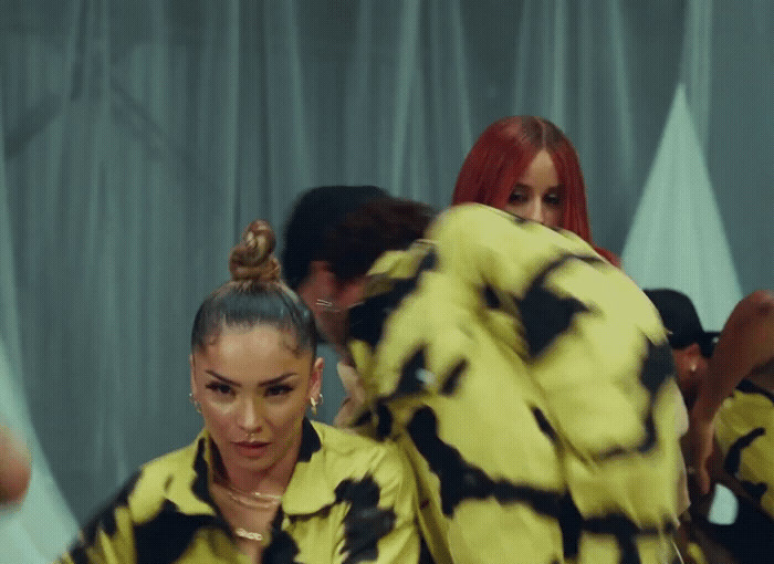 a group of women in yellow and black outfits