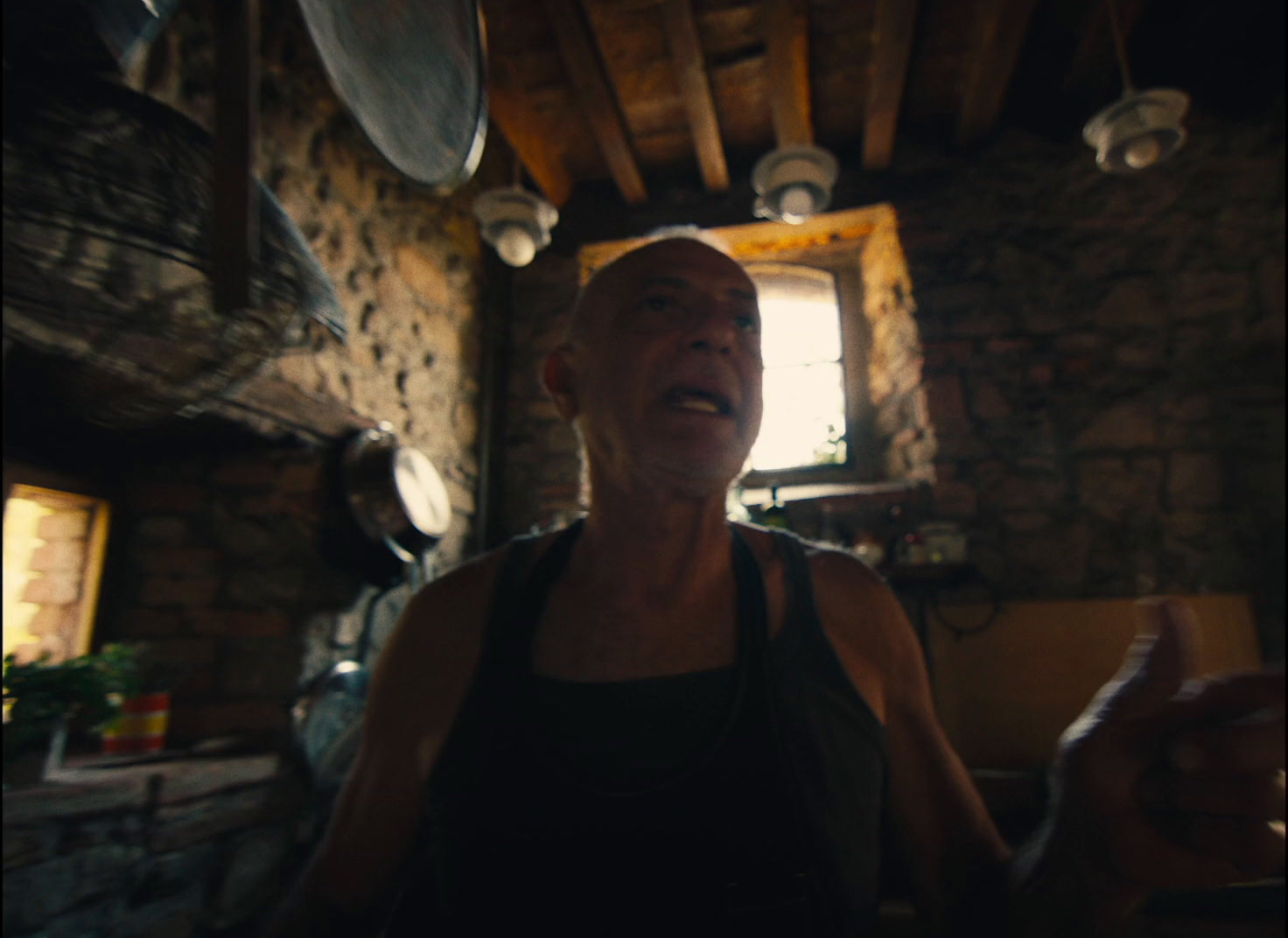 a woman standing in a kitchen next to a window