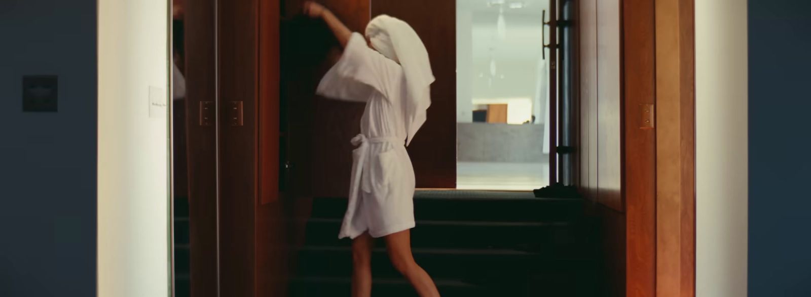 a person in a robe standing in a doorway