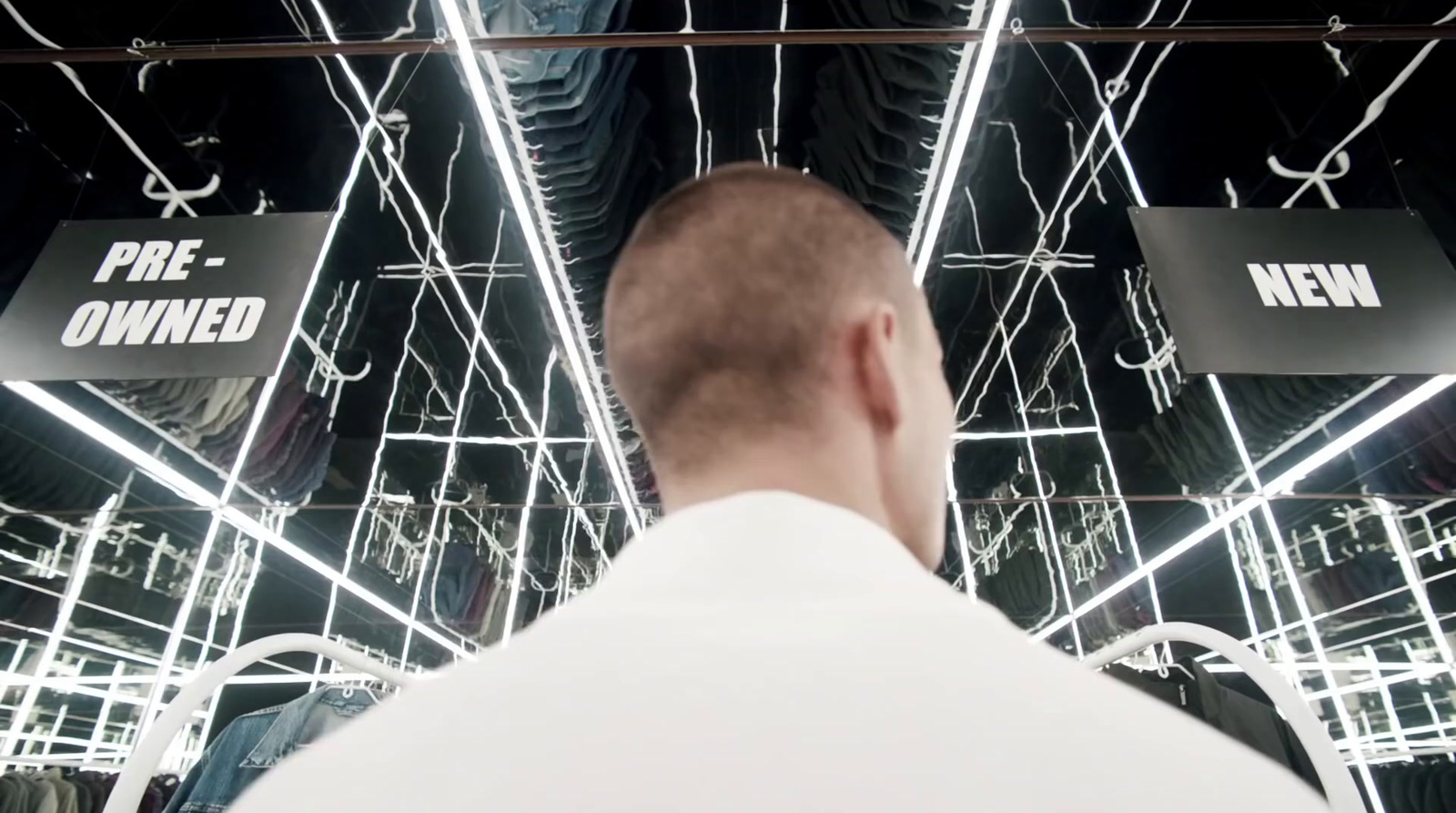 a man standing in front of a mirror in a store