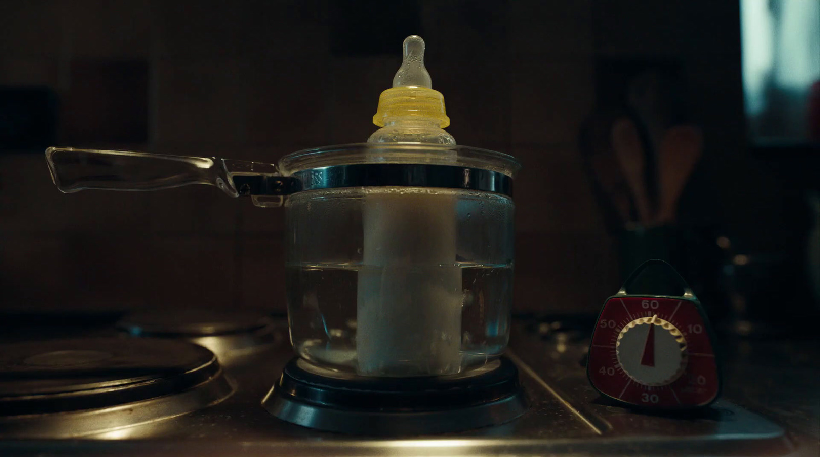 a baby bottle sitting on top of a stove