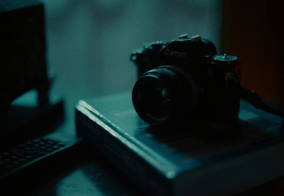 a camera sitting on top of a book on a table