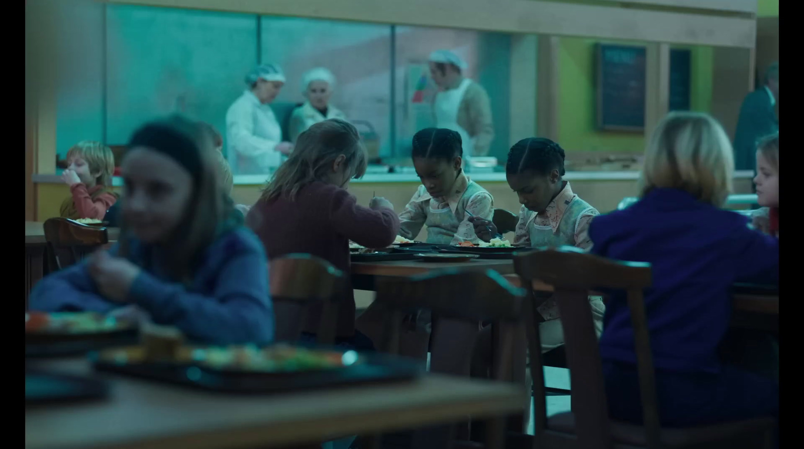 a group of people sitting at a table in a restaurant