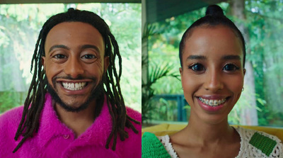 a man and a woman with dreadlocks smiling