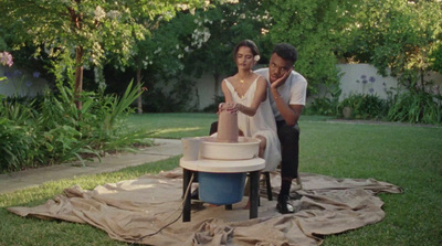 a man standing next to a woman in a yard