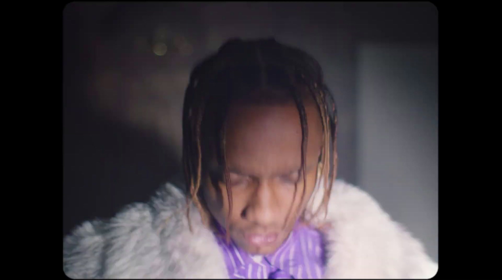 a man with dreadlocks and a purple bow tie