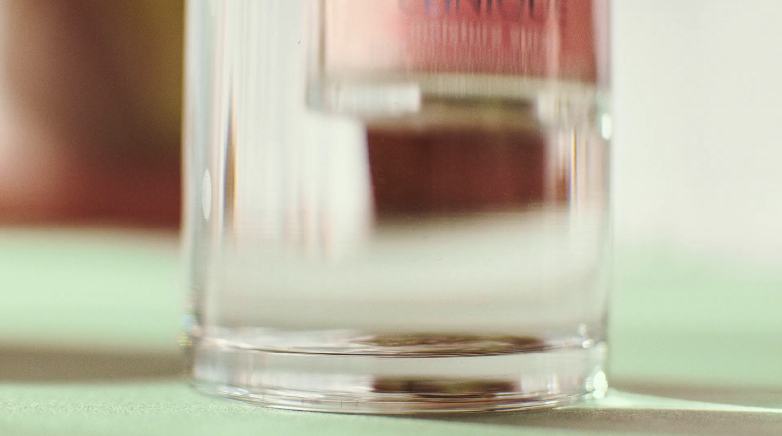 a glass filled with liquid sitting on top of a table