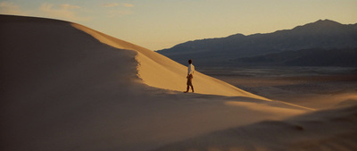 a person standing in the middle of a desert