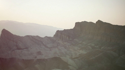 a view of a mountain range with mountains in the background