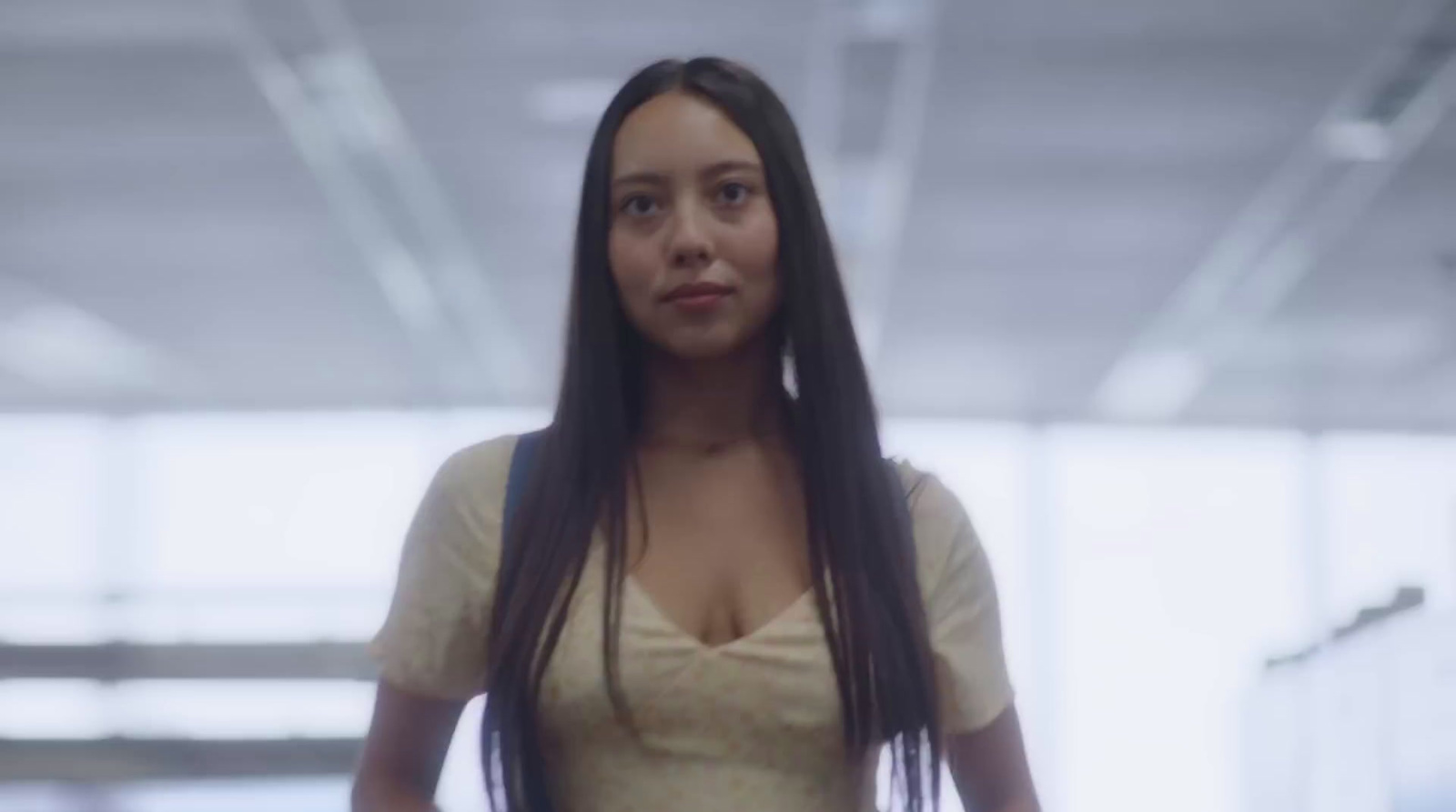 a woman with long hair standing in a building