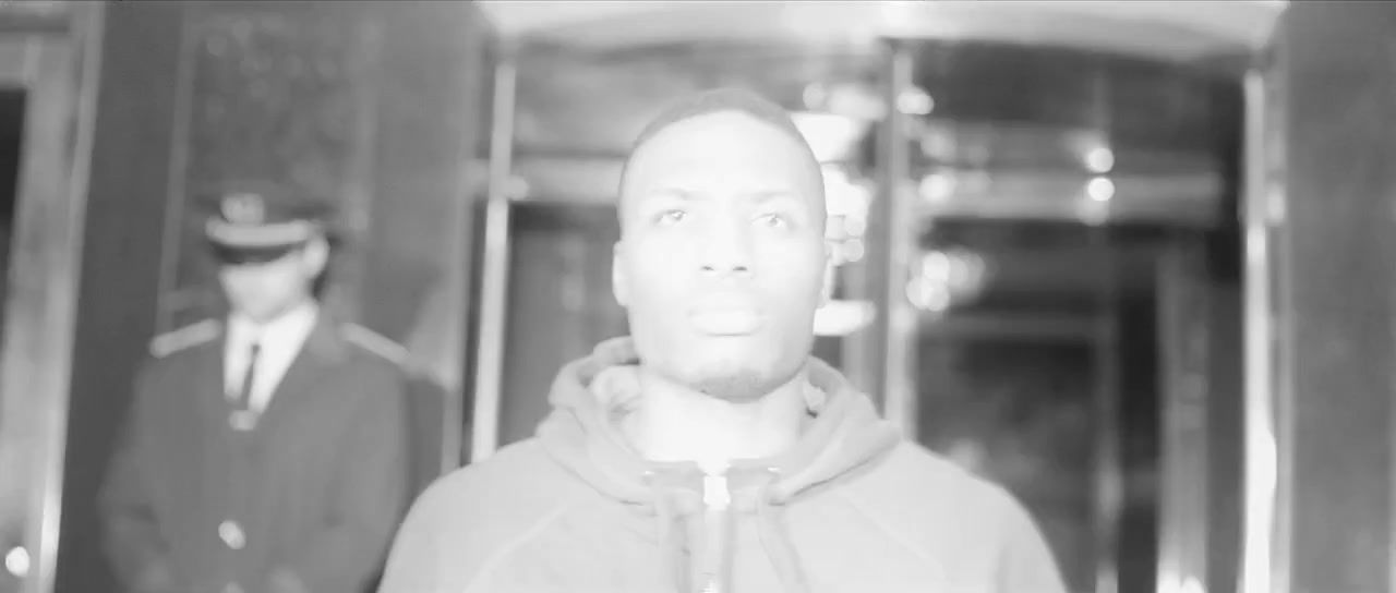 a black and white photo of a man wearing a hoodie