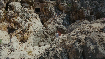 a group of people standing on top of a rocky cliff