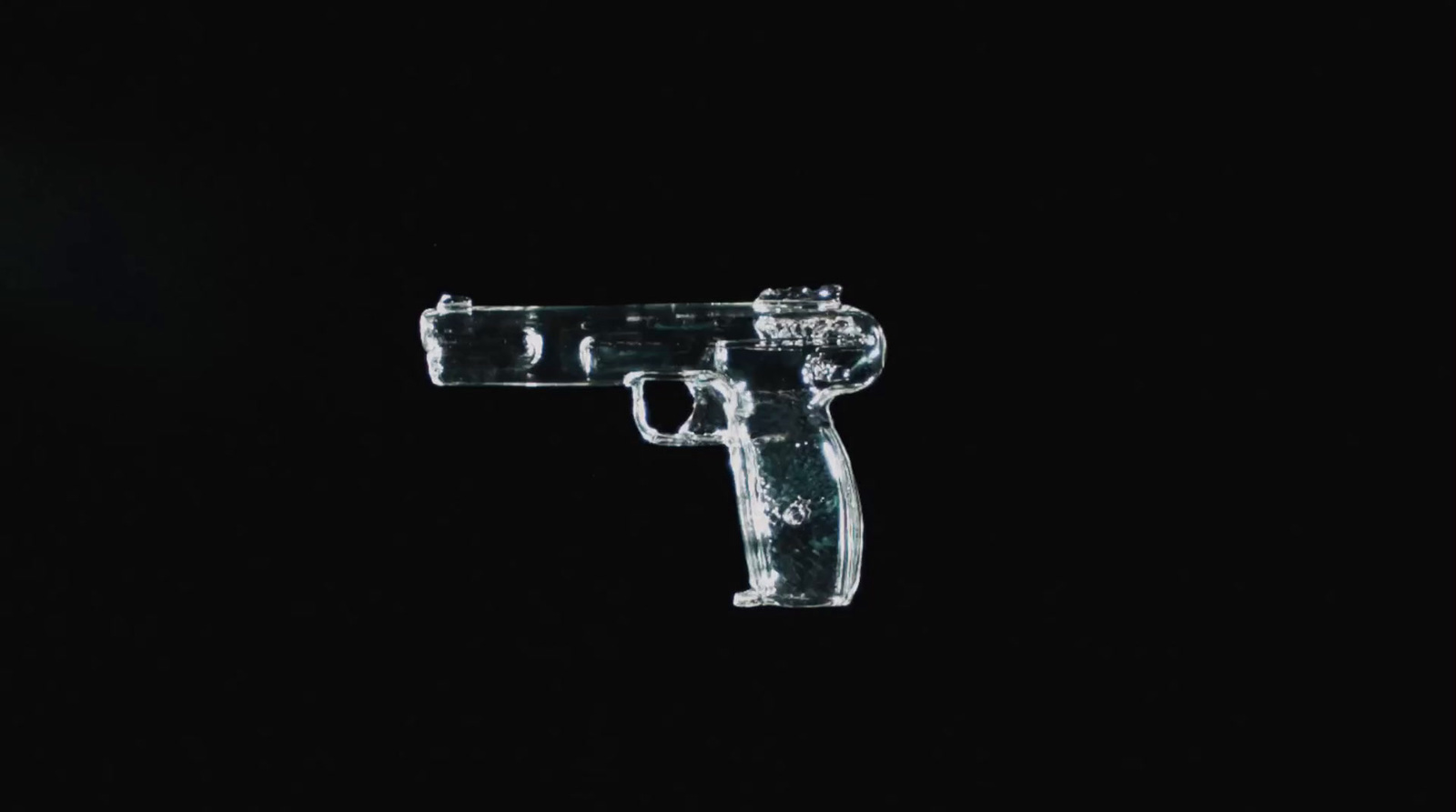 a plastic gun in the dark on a black background