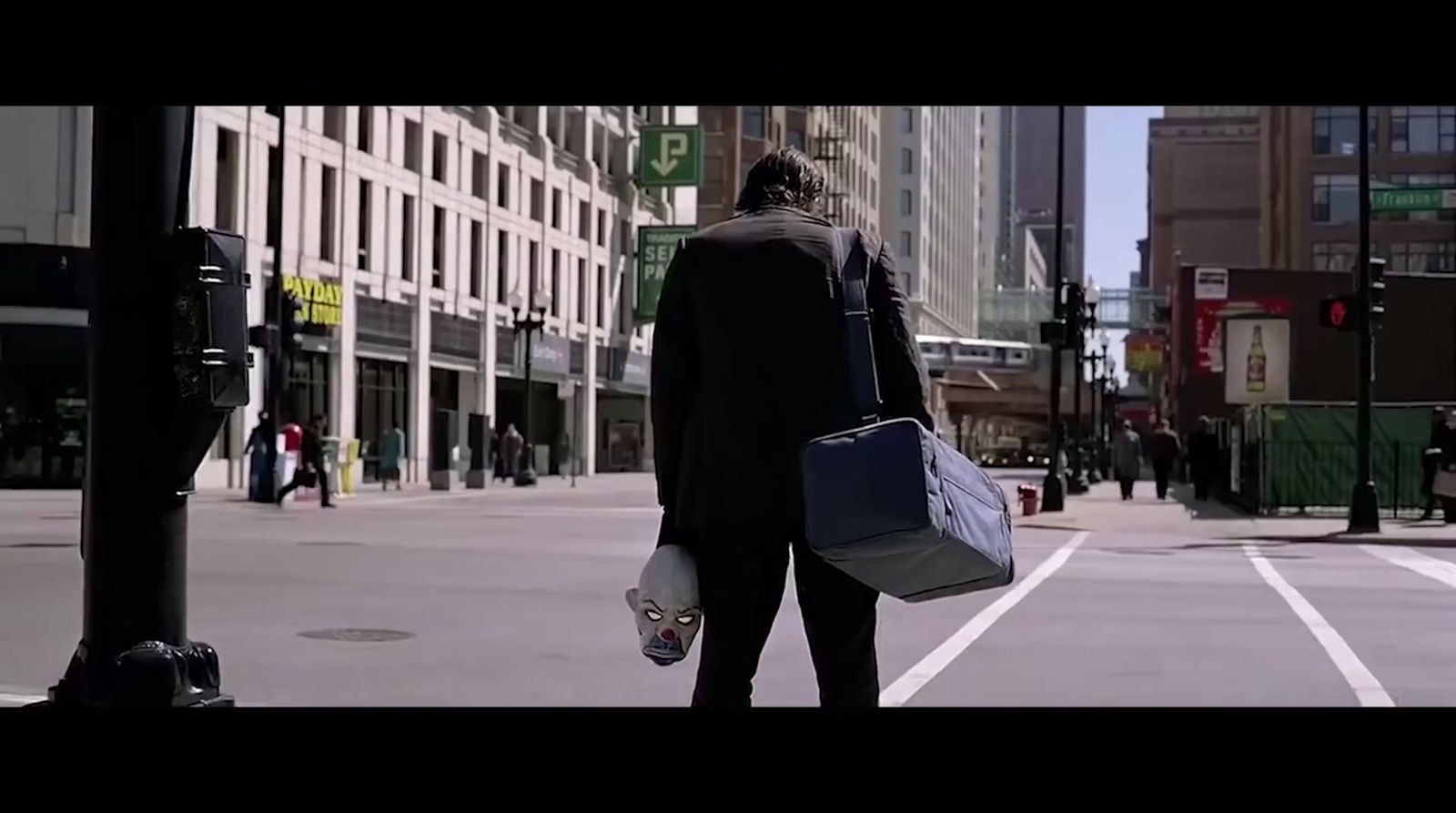 a woman walking down a street holding a bag