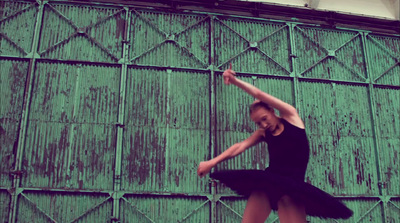 a woman in a black dress is dancing