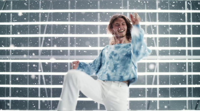 a man is dancing in the snow in front of a window