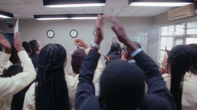 a group of people raising their hands in the air