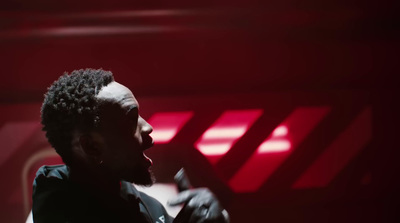 a man standing in a room with a red light