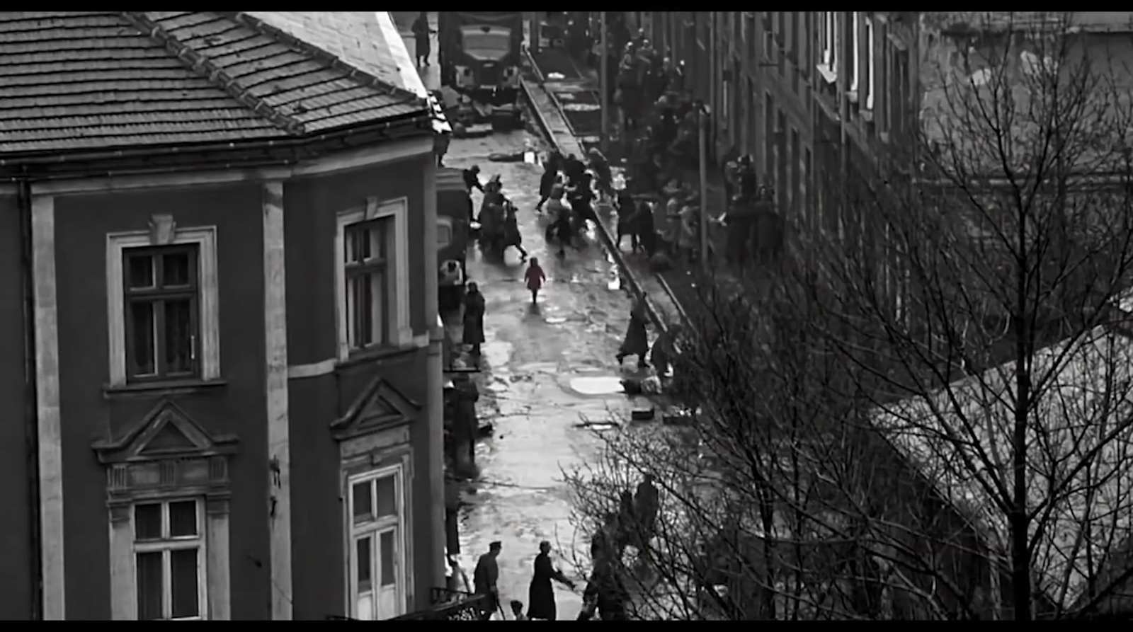 a black and white photo of people walking down a street