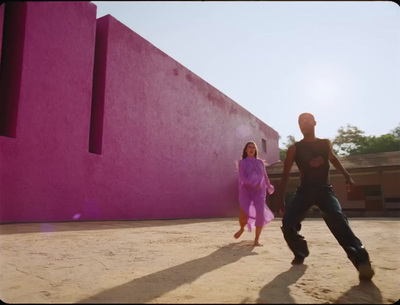 a man and a woman are playing with a frisbee